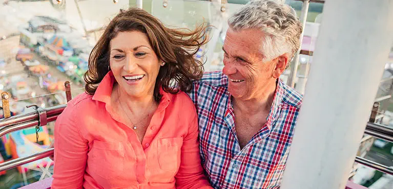 couple riding ferris wheel enjoying retirement