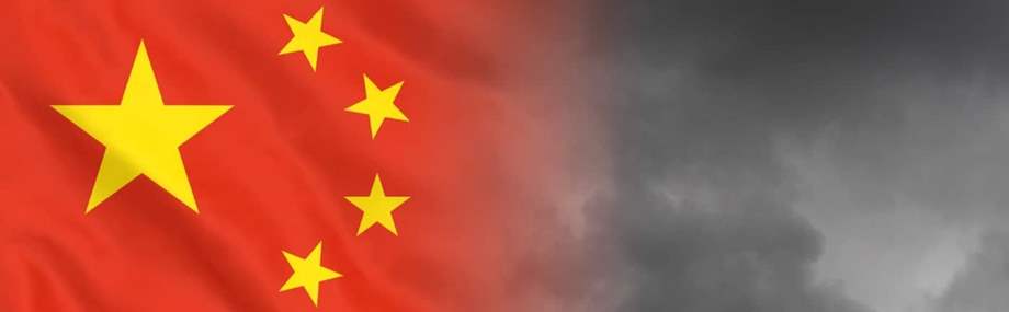 China economics financial crisis concept. Stock photo of China's flag in front of a dark cloud background.