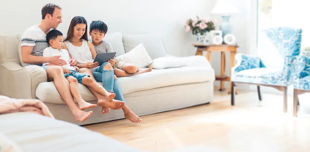 family on couch reviewing life insurance policies